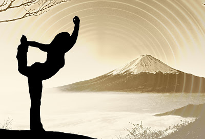 Woman standing in meditation pose with mountain in background